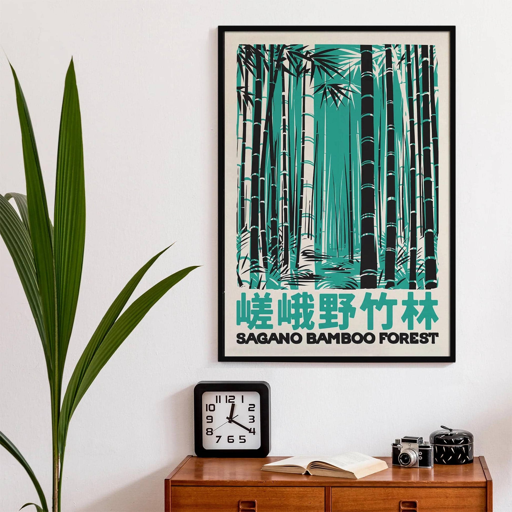 Framed artwork of a bamboo forest with Japanese text on a wall above a wooden cabinet.